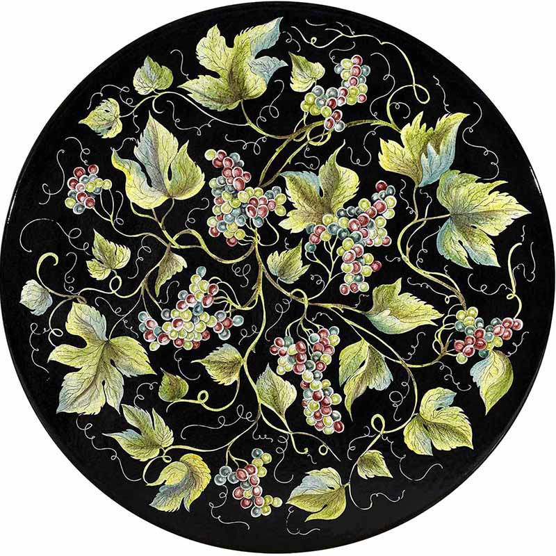 Tavolo rotondo dipinto a mano con uva e foglie su uno sfondo nero